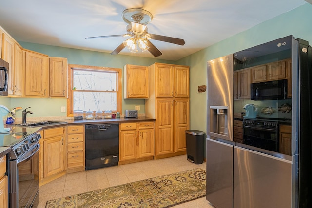 kitchen featuring black appliances, dark countertops, a sink, and a ceiling fan