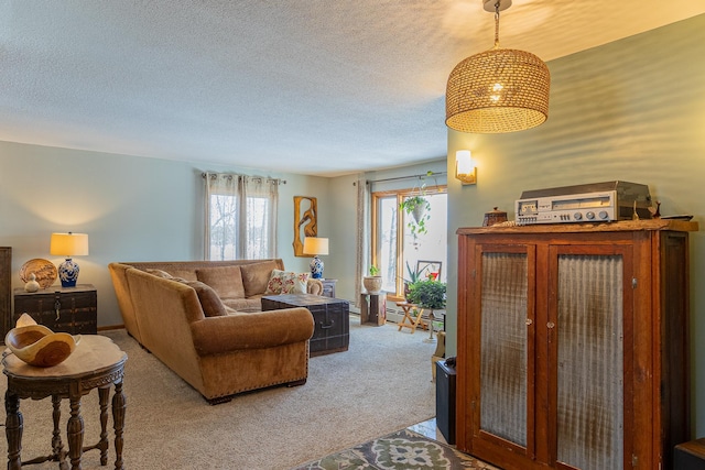 living area with light colored carpet and a textured ceiling