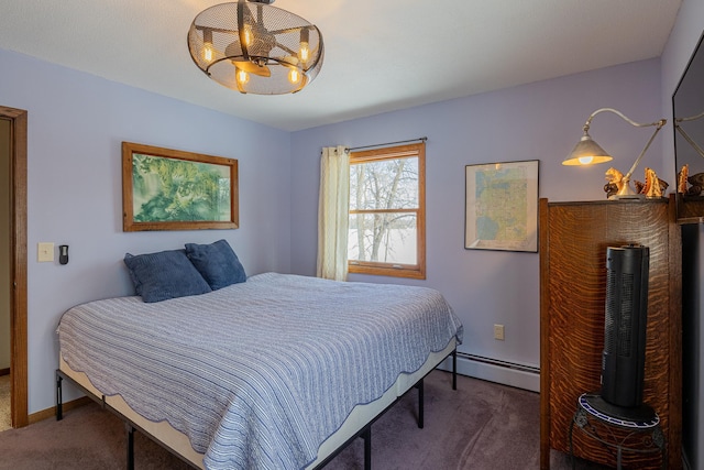 bedroom with an inviting chandelier, a baseboard radiator, baseboards, and dark colored carpet