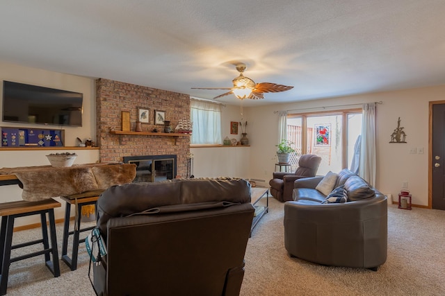 living room with ceiling fan, a textured ceiling, light carpet, baseboards, and a brick fireplace