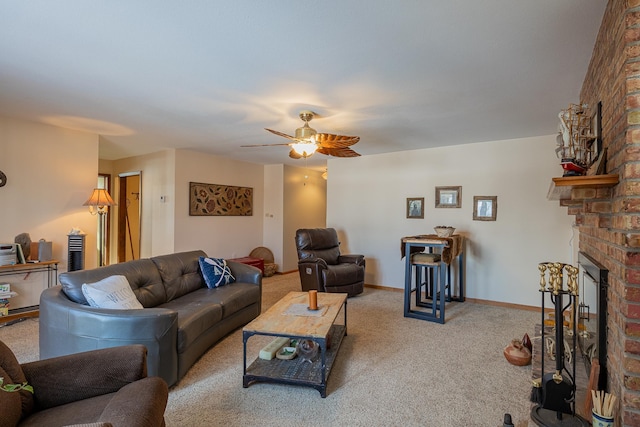 living area with a brick fireplace, ceiling fan, baseboards, and light colored carpet