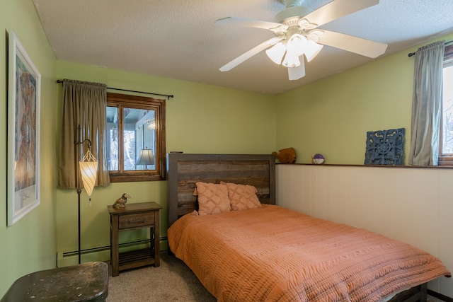 bedroom with light carpet, baseboard heating, and a textured ceiling