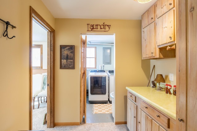 interior space featuring washing machine and dryer, baseboards, light countertops, and light brown cabinetry