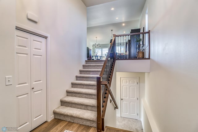 stairs featuring hardwood / wood-style floors