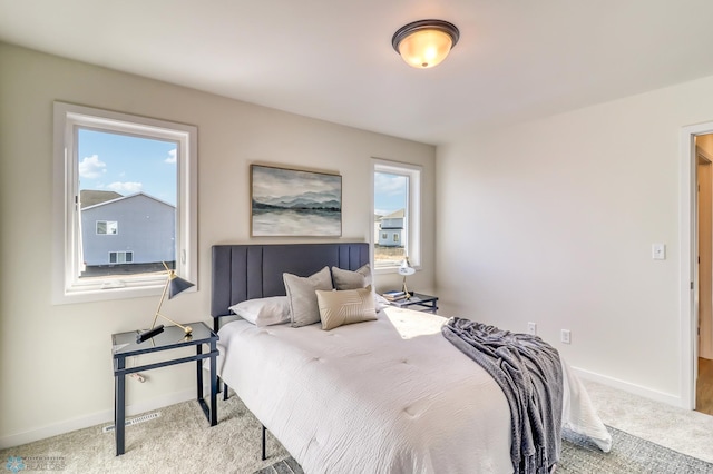 bedroom featuring light colored carpet