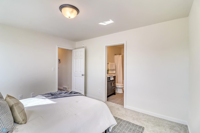 carpeted bedroom featuring ensuite bathroom