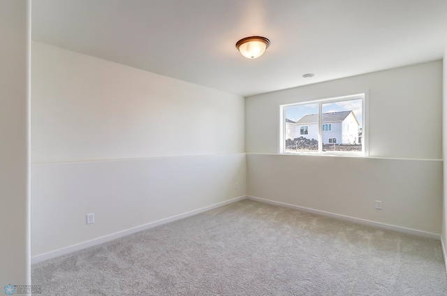 unfurnished room with light colored carpet