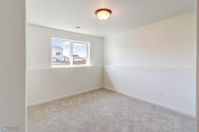 unfurnished room with light colored carpet