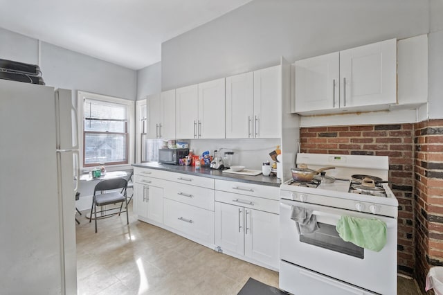 kitchen with white cabinetry and white appliances