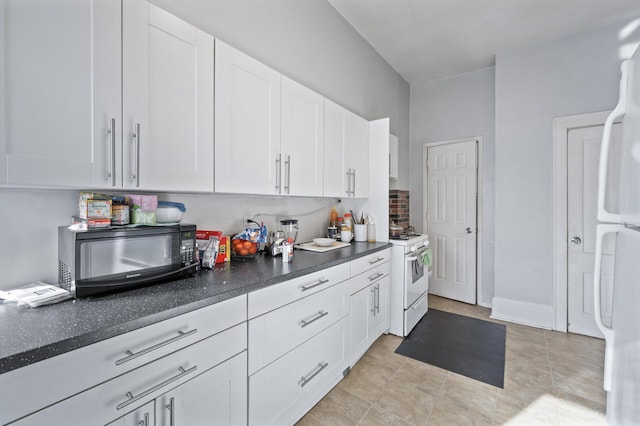 kitchen featuring white cabinetry and white appliances