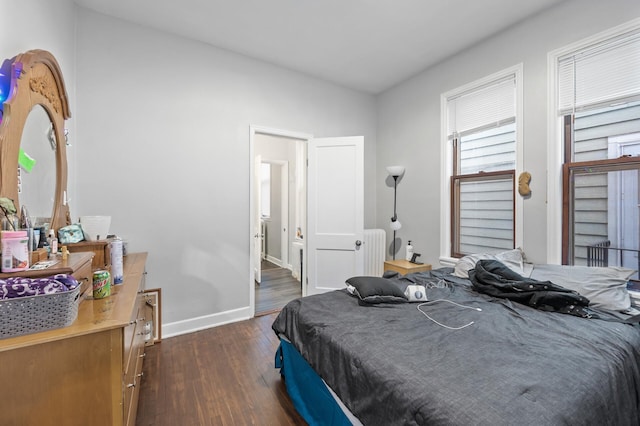 bedroom featuring dark hardwood / wood-style flooring and radiator