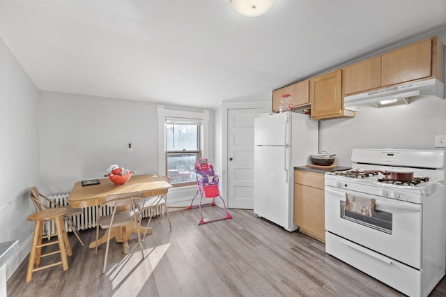 kitchen with light brown cabinetry, radiator, white appliances, and light wood-type flooring