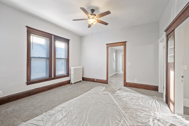 bedroom featuring ceiling fan, light colored carpet, and radiator