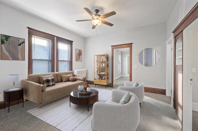 living room featuring radiator, light carpet, and ceiling fan