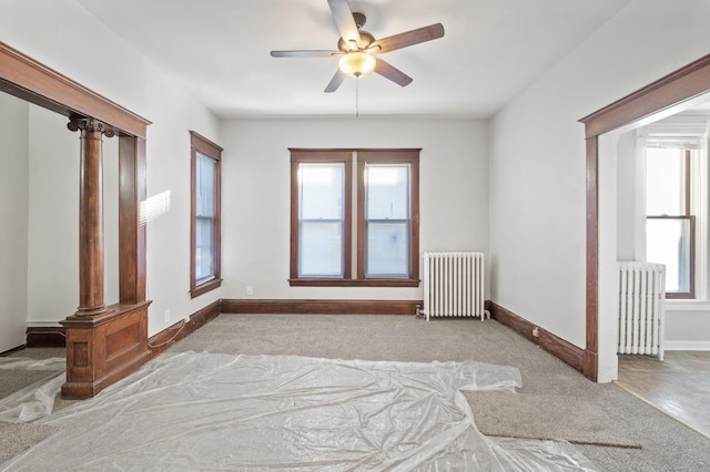 empty room featuring radiator heating unit and ceiling fan