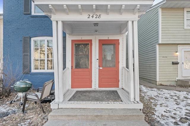 view of snow covered property entrance