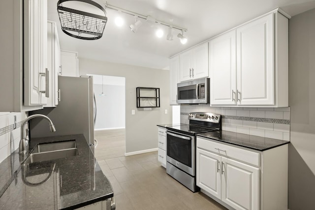 kitchen featuring appliances with stainless steel finishes, sink, decorative backsplash, and white cabinets