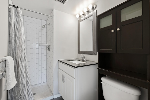 bathroom featuring vanity, curtained shower, and toilet