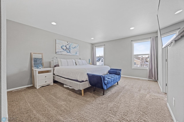 bedroom with carpet floors and multiple windows