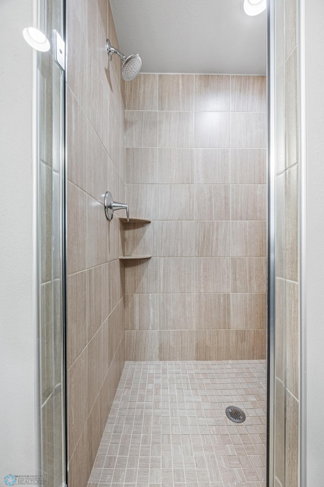 bathroom with tiled shower