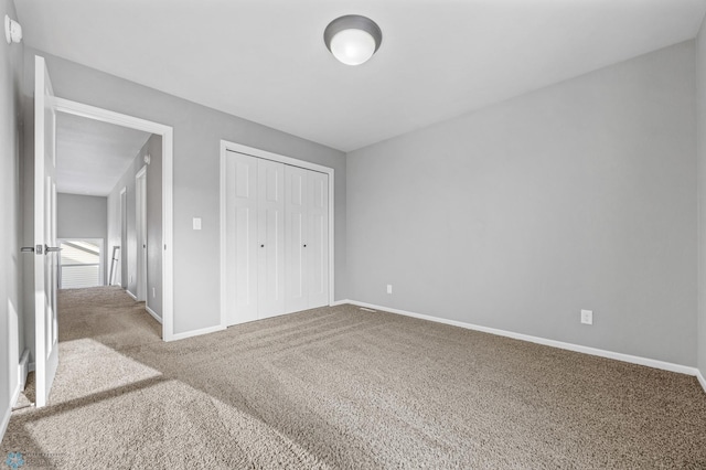 unfurnished bedroom with carpet floors and a closet