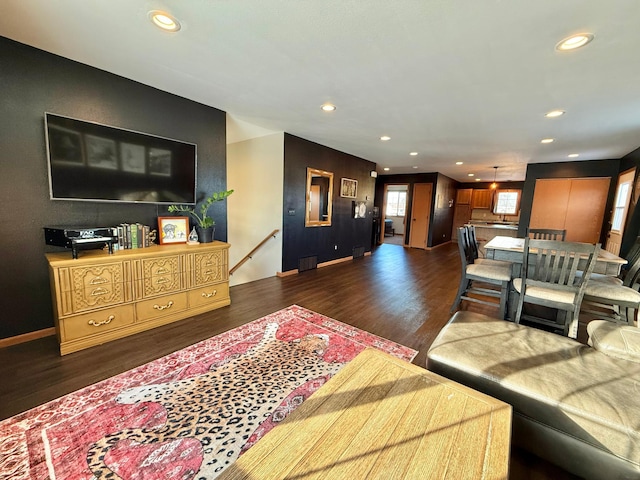 living room with dark hardwood / wood-style flooring