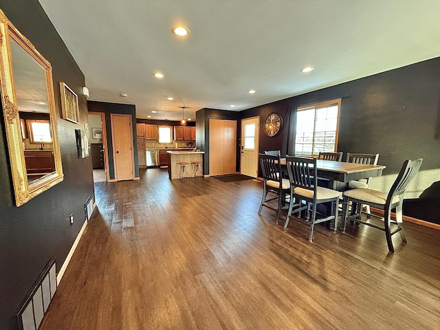 dining area featuring dark wood-type flooring