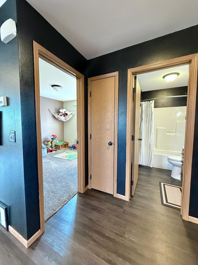 corridor with dark wood-type flooring