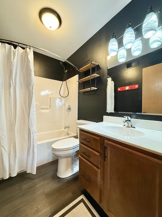 full bathroom with wood-type flooring, vanity, shower / tub combo with curtain, and toilet