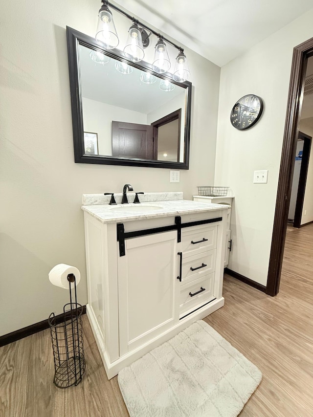 bathroom featuring vanity and hardwood / wood-style floors