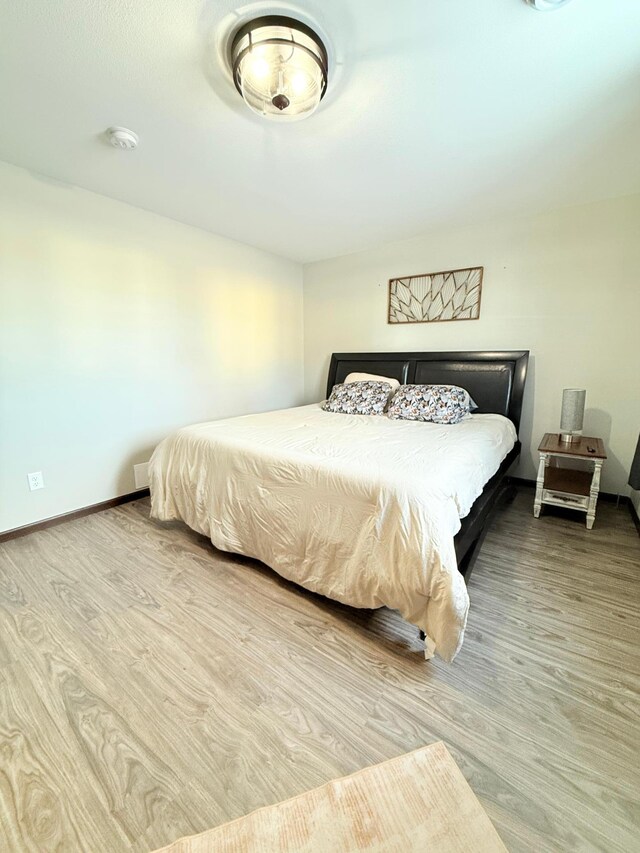 bedroom with hardwood / wood-style floors