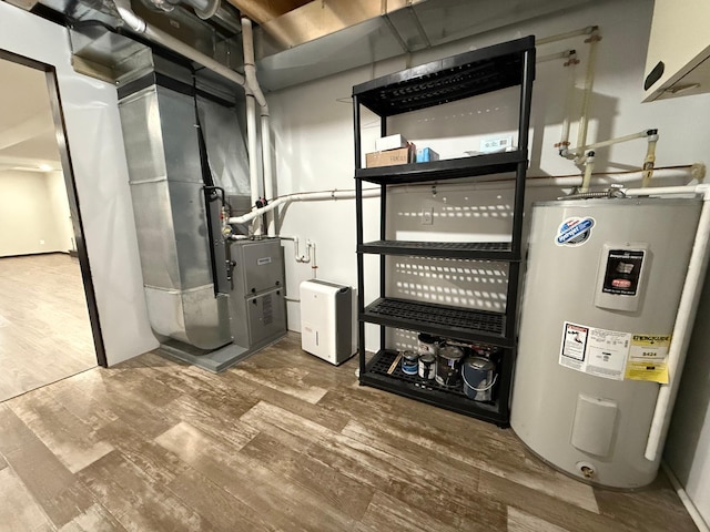 utility room featuring electric water heater and heating unit