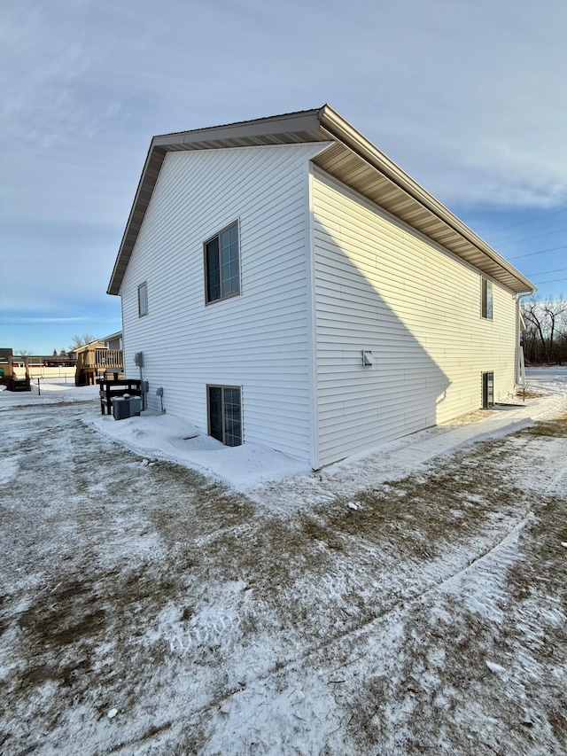 view of snow covered exterior featuring a deck