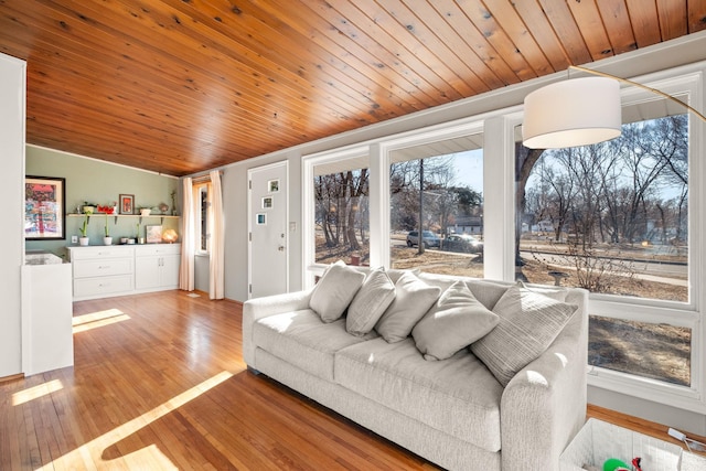 living room featuring vaulted ceiling, wooden ceiling, and light wood-type flooring