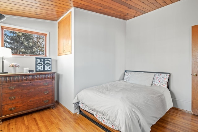 bedroom with wood ceiling and light hardwood / wood-style flooring