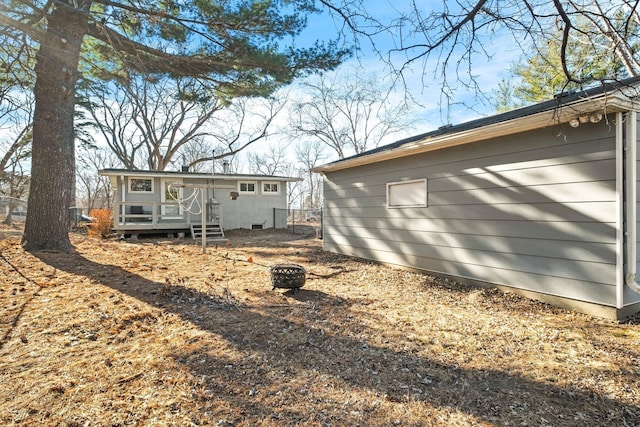 back of house featuring a fire pit