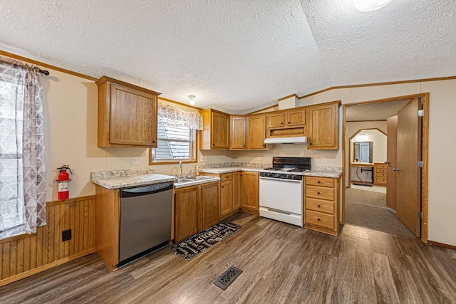 kitchen with lofted ceiling, wood walls, a textured ceiling, stainless steel dishwasher, and white gas range oven