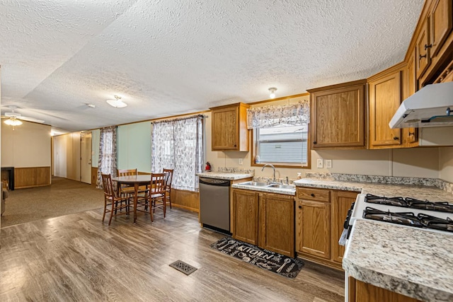 kitchen featuring hardwood / wood-style flooring, dishwasher, sink, and ceiling fan