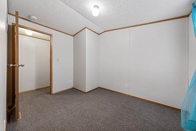 carpeted spare room featuring crown molding, vaulted ceiling, and a textured ceiling