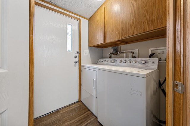 laundry room featuring independent washer and dryer, dark hardwood / wood-style floors, cabinets, and a textured ceiling