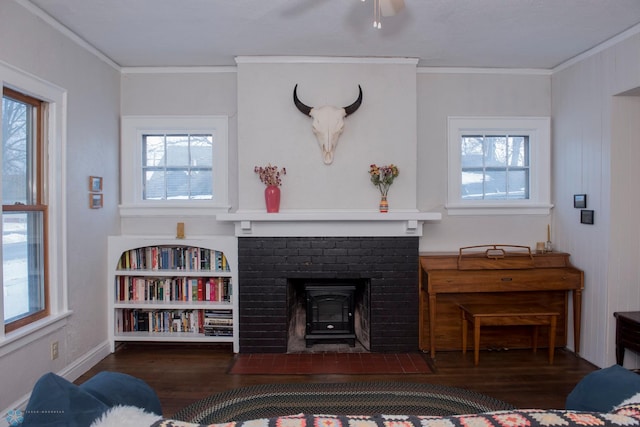 living room featuring crown molding, dark hardwood / wood-style floors, and a wood stove