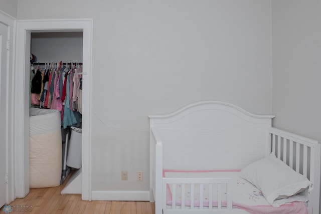 bedroom featuring light hardwood / wood-style floors and a closet