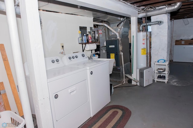 clothes washing area with heating unit, sink, washing machine and dryer, and water heater