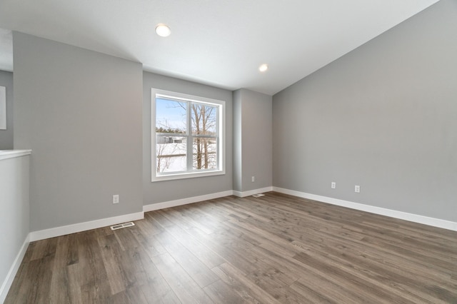 spare room with hardwood / wood-style flooring