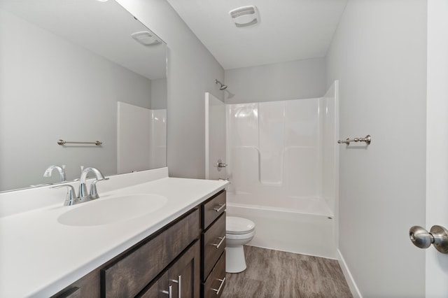 full bathroom with vanity, hardwood / wood-style floors, toilet, and shower / bath combination