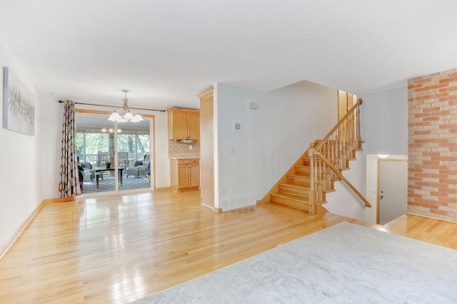 living room featuring a chandelier and light hardwood / wood-style flooring