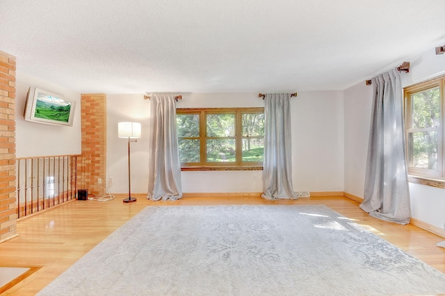 spare room with wood-type flooring and a textured ceiling