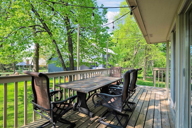 wooden terrace featuring a lawn