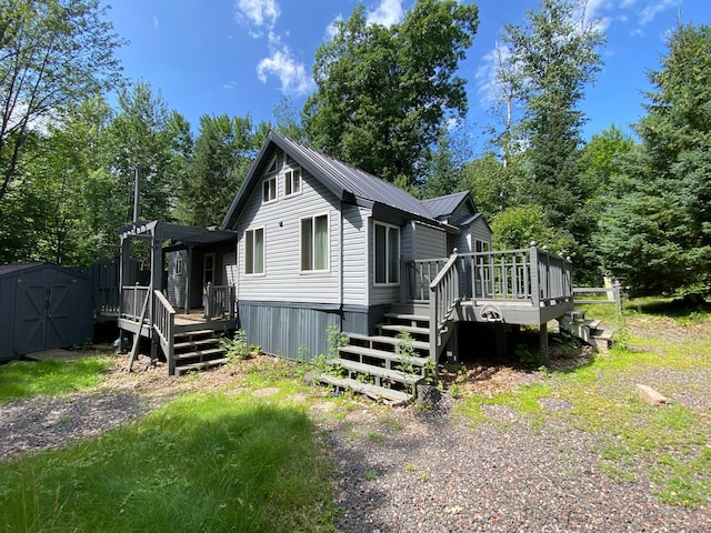 exterior space featuring a shed and a wooden deck