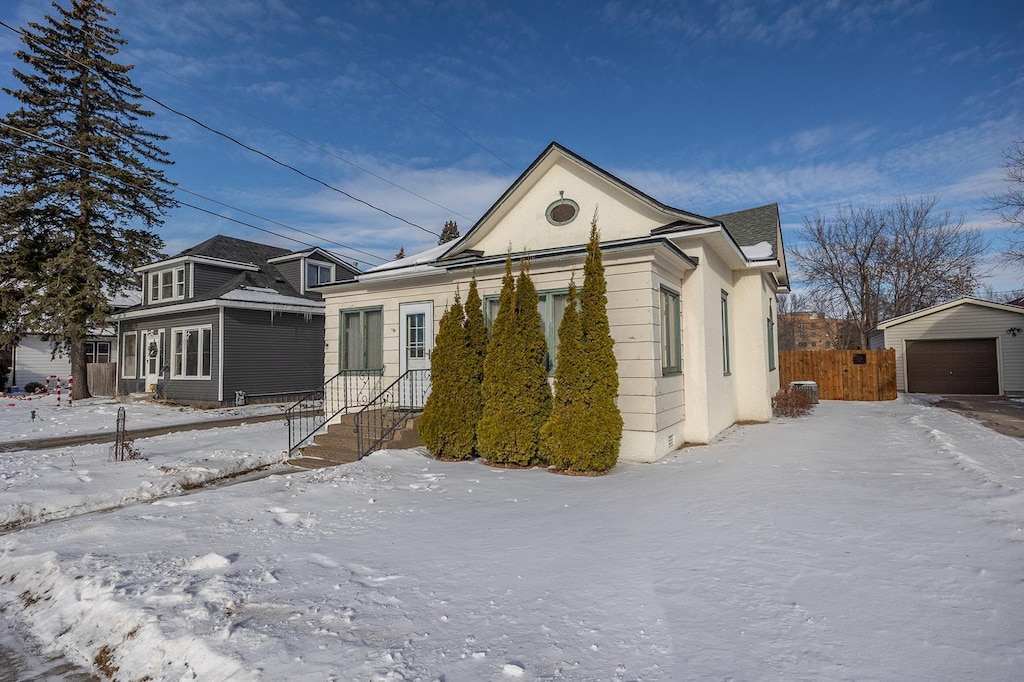 view of front of home with a garage and an outdoor structure